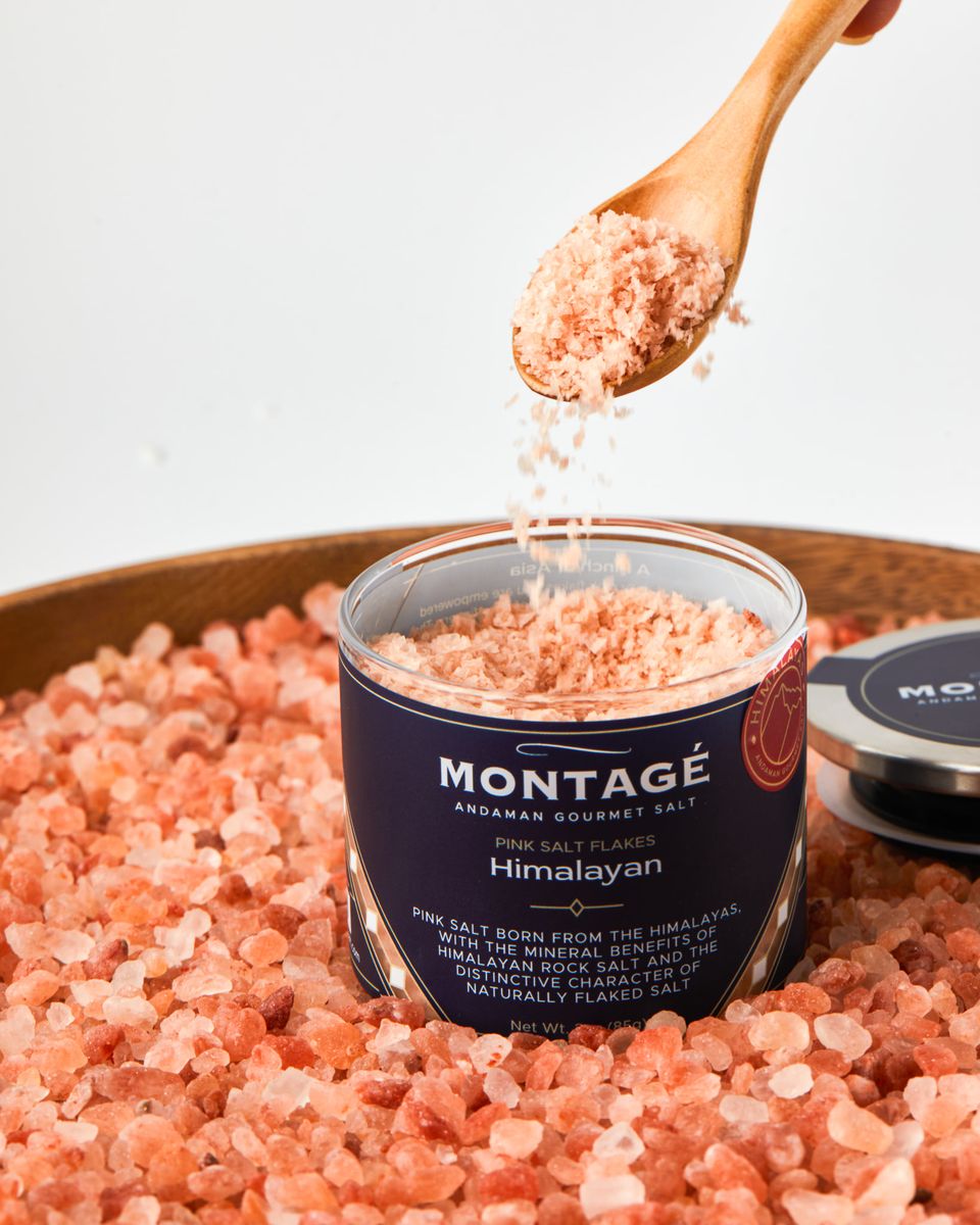 Himalayan flaky salt in a glass jar with a blue label