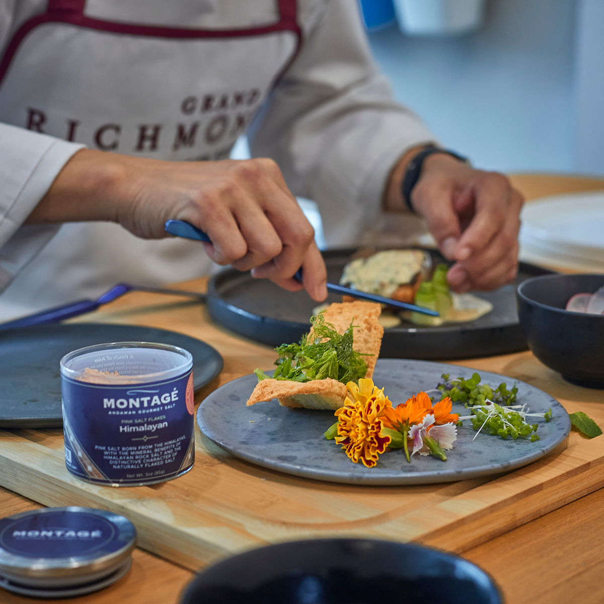 Chef finishing a plate with himalayan flakes