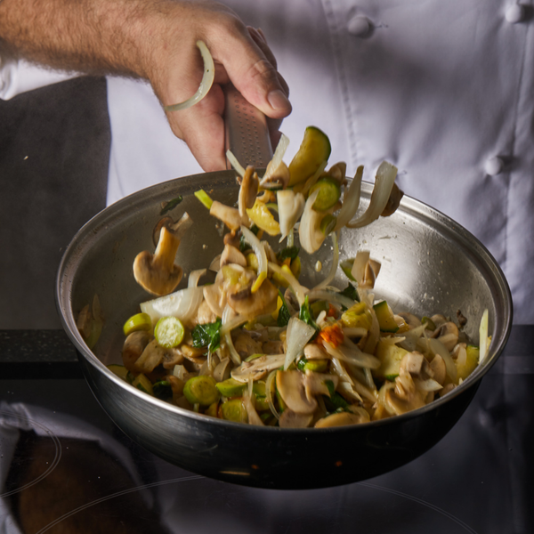Person cooking chicken stir fry with chicken stir fry seasoning