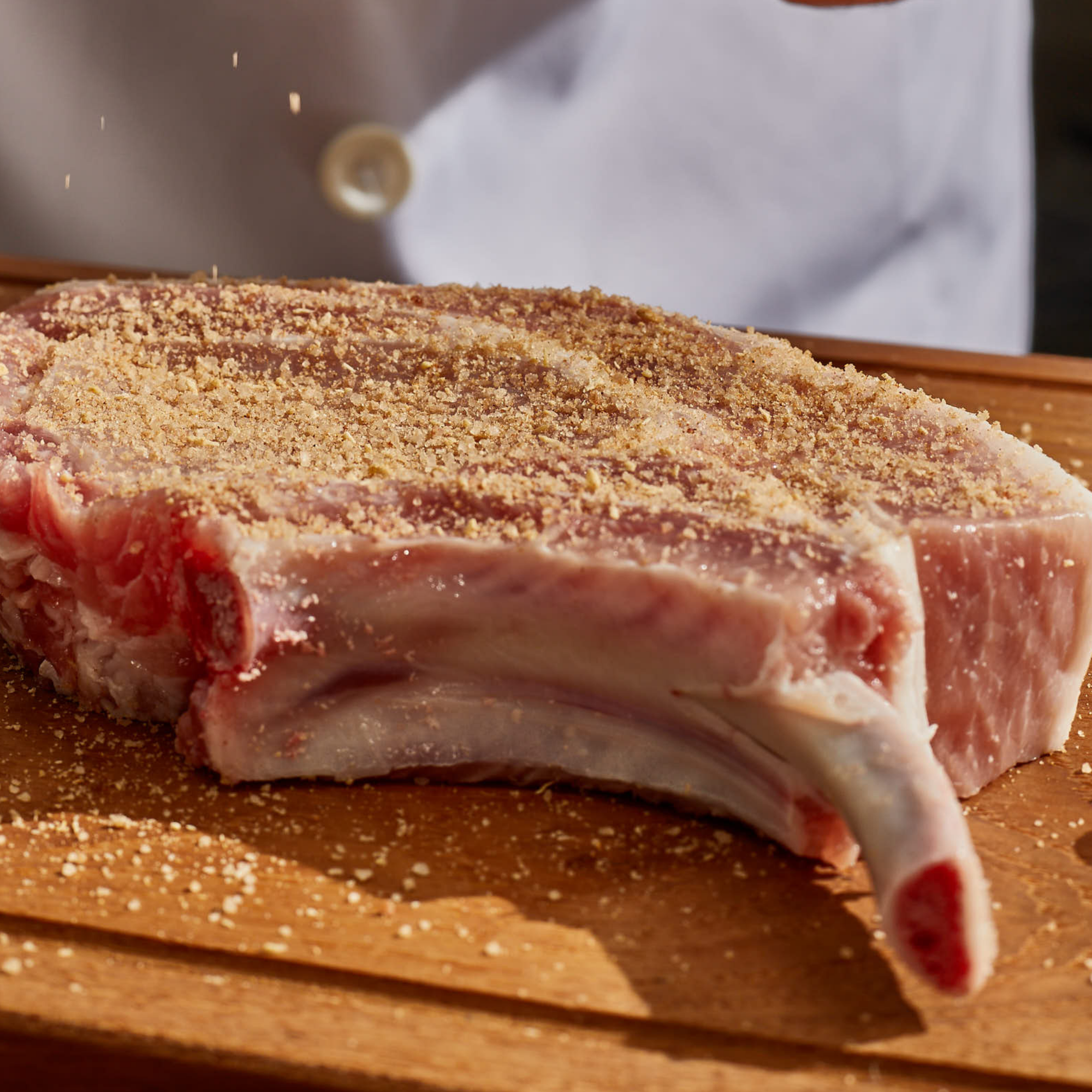 pork chop seasoning on a fresh port chop