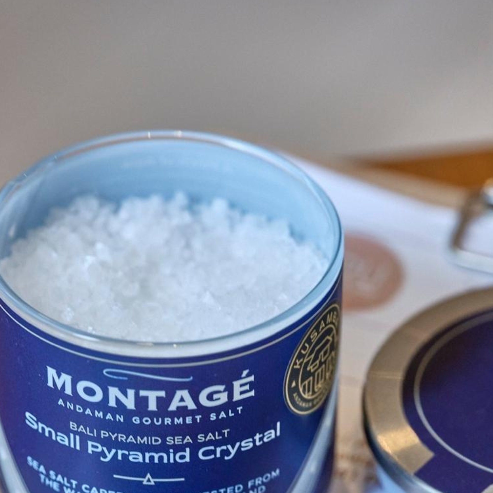 Montage Andaman Gourmet Salt container with coarse sea salt inside on a white surface.