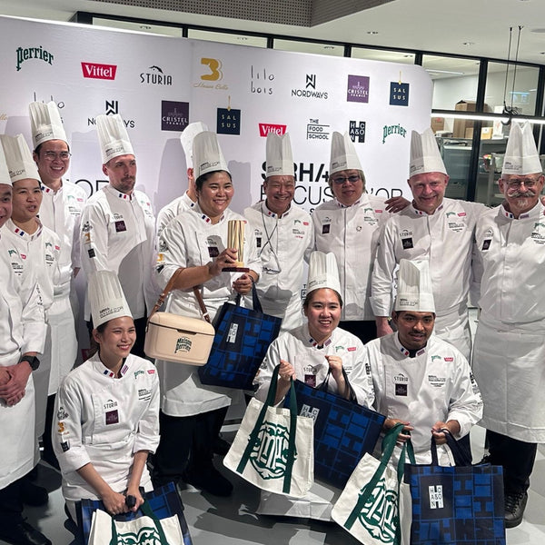 Chefs in Bocuse d'Or Thailand jackets holding a trophy at the event where Montagé salt is used