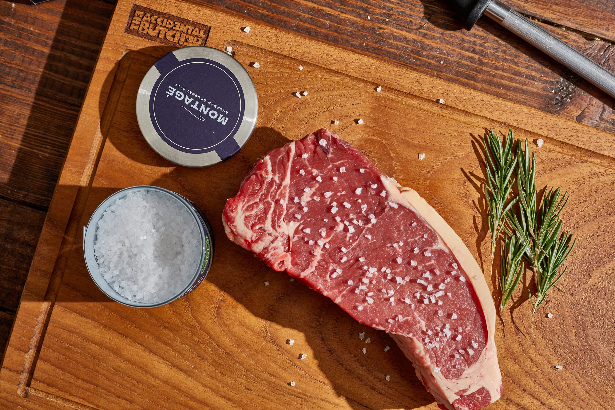 Raw strip steak salted with Montagé Kusamba pyramid crystals and fresh rosemary