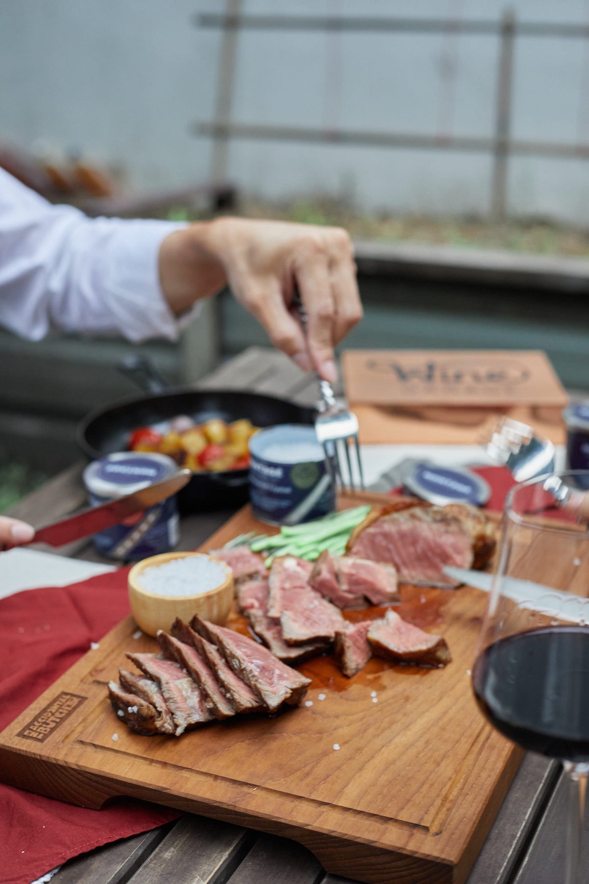 Overhead view of sliced pan-seared strip steak and Montagé Kusamba salt on The Accidental Butcher board