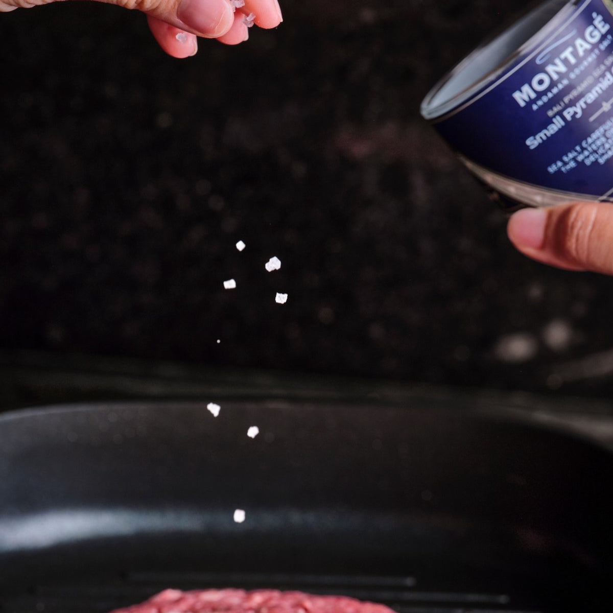 Pinching Montagé Kusamba small pyramid salt onto a burger