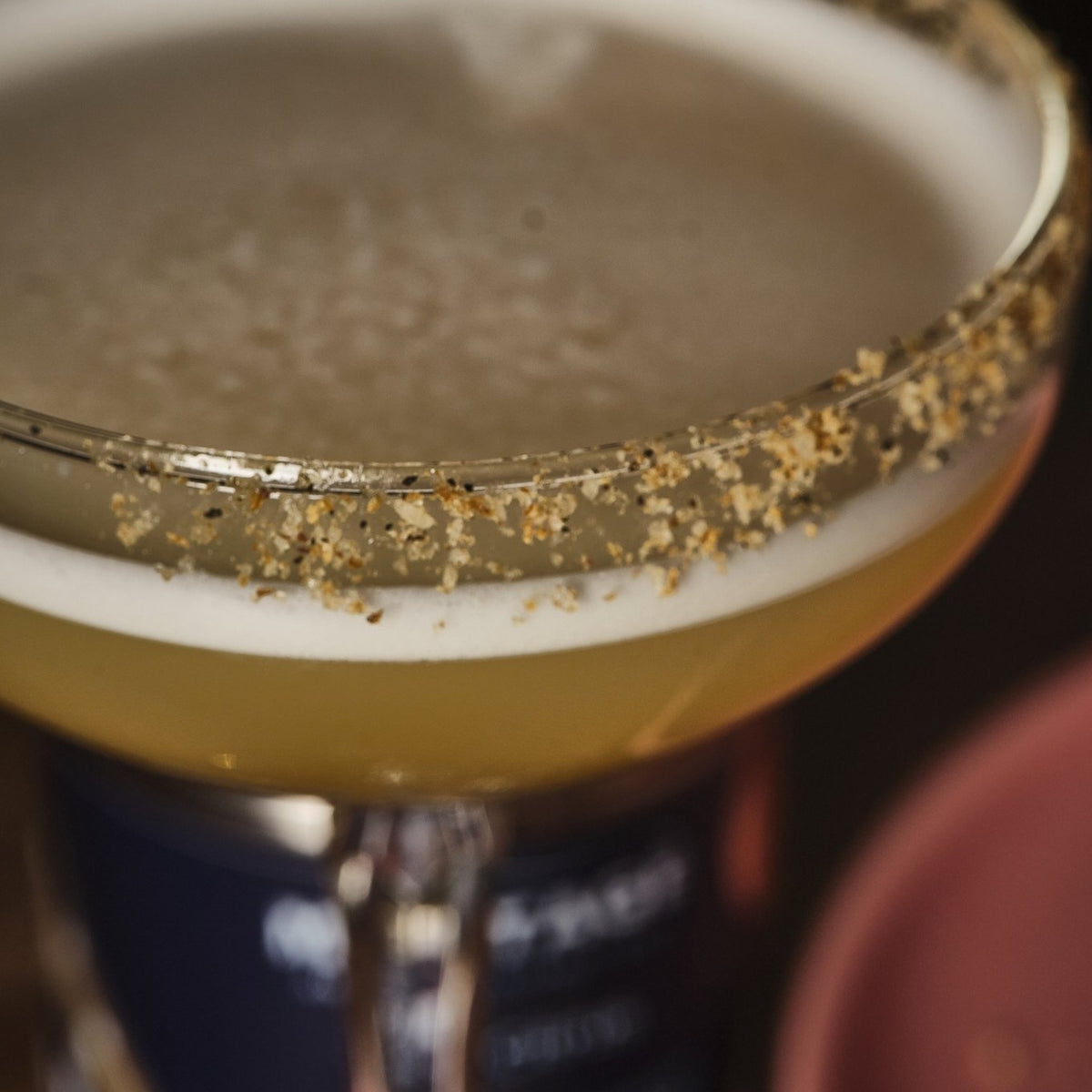 Close-up of a cocktail coupe rimmed with Montagé Yuzu Citrus salt
