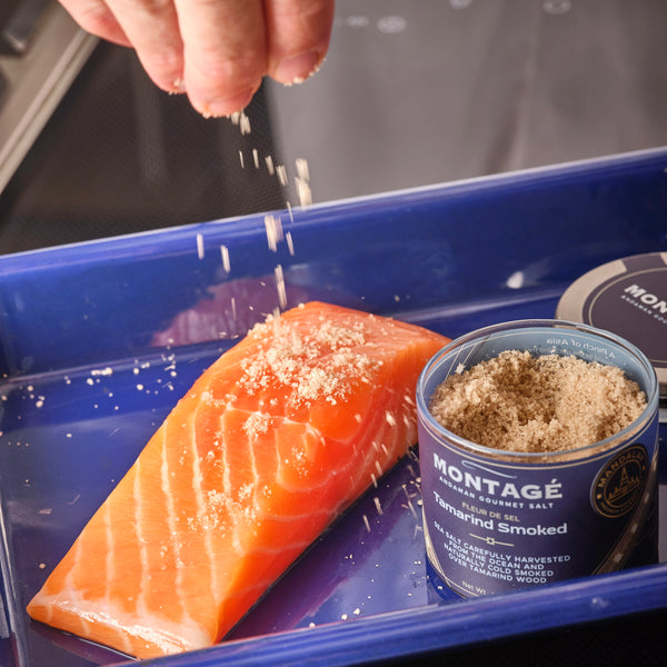 Smoked Gourmet Salt | Tamarind Smoked | 4oz Glass Jar garnishing fresh salmon 
