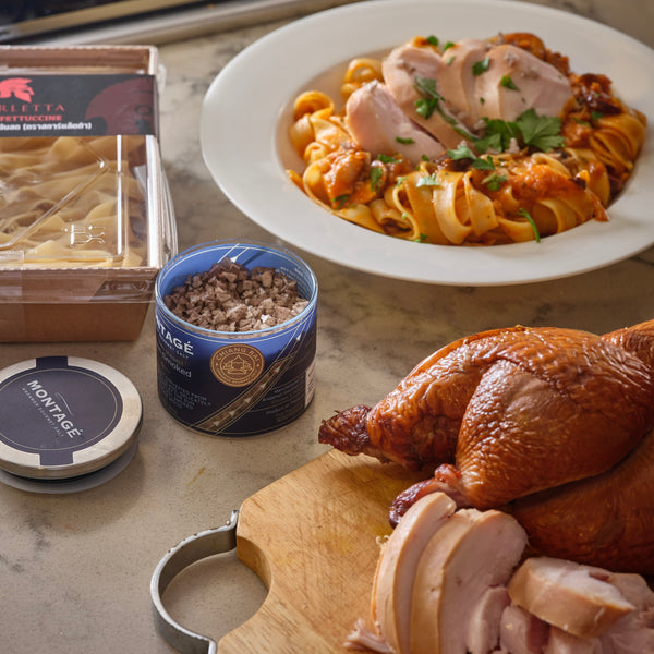 a display of pasta with smoked chicken together with an opened glass jar of montage smoked salt